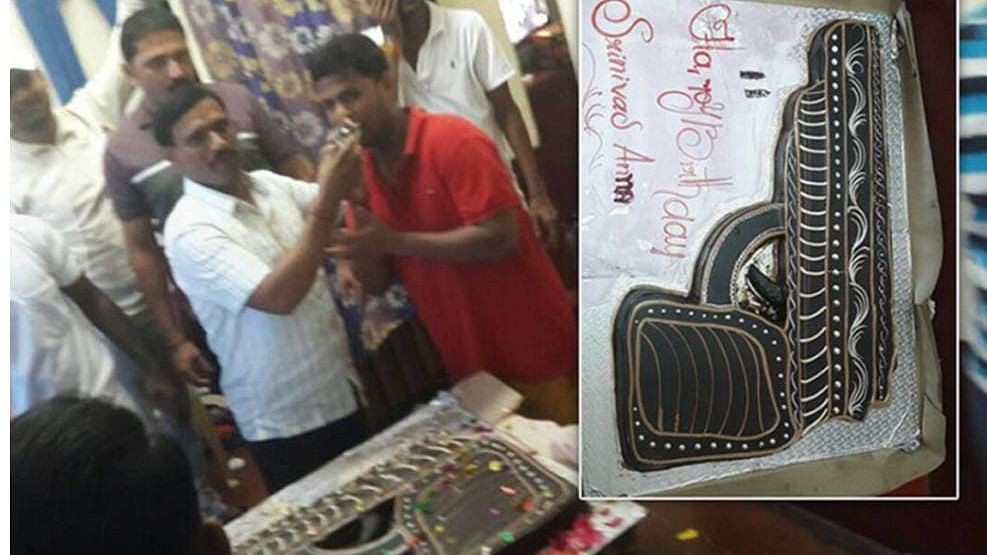 <div class="paragraphs"><p>This undated photograph, taken from inside a cell at Bengaluru's Parappana Agrahara Central Prison, shows rowdy Srinivas alias 'Kulla' Seena (white shirt) celebrating his birthday with a gun-shaped cake (inset).</p></div>